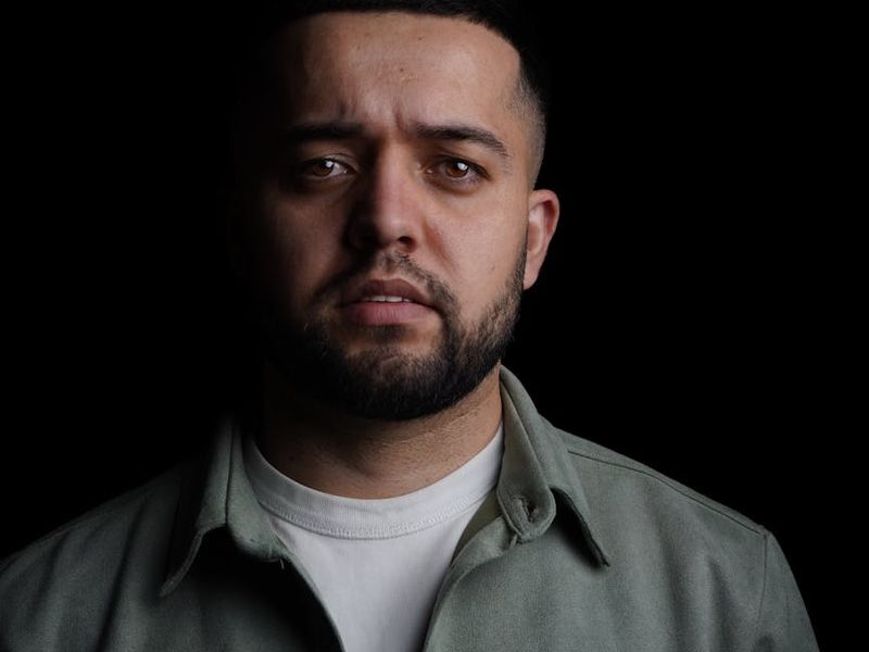 Detailed view of person moving in a dark studio setting.